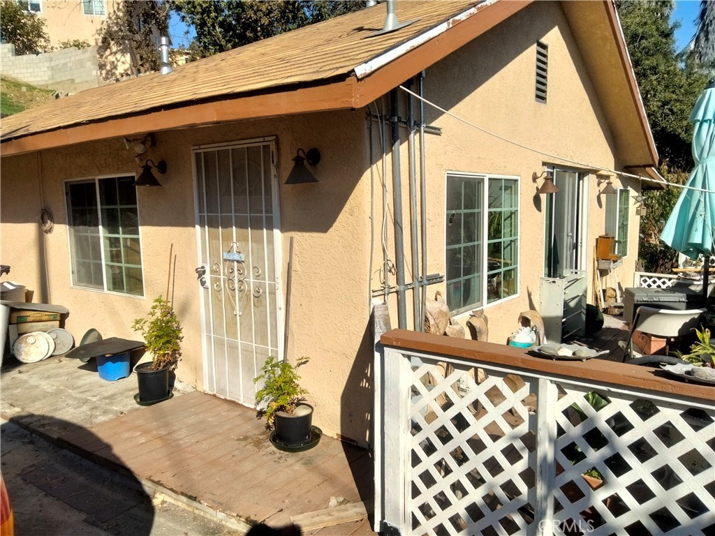 a view of balcony with two chairs and a large window