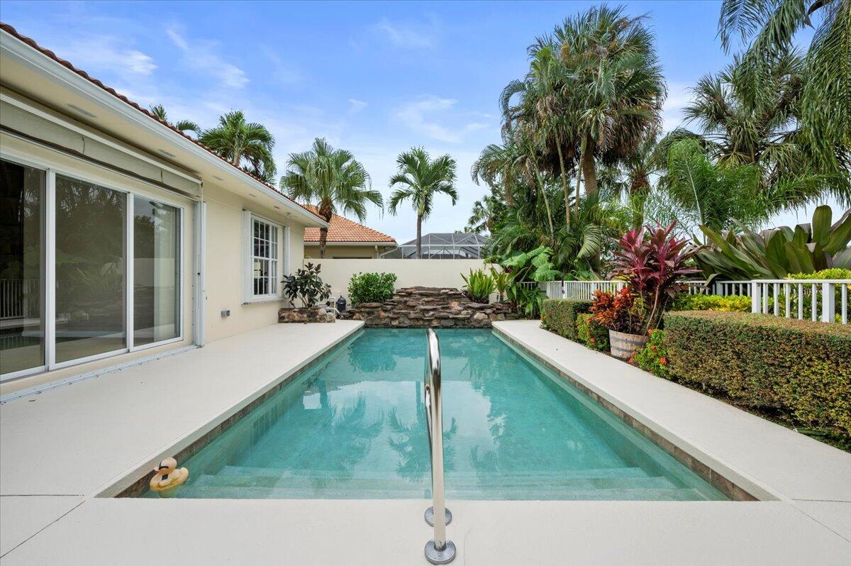 a swimming pool view with a garden space