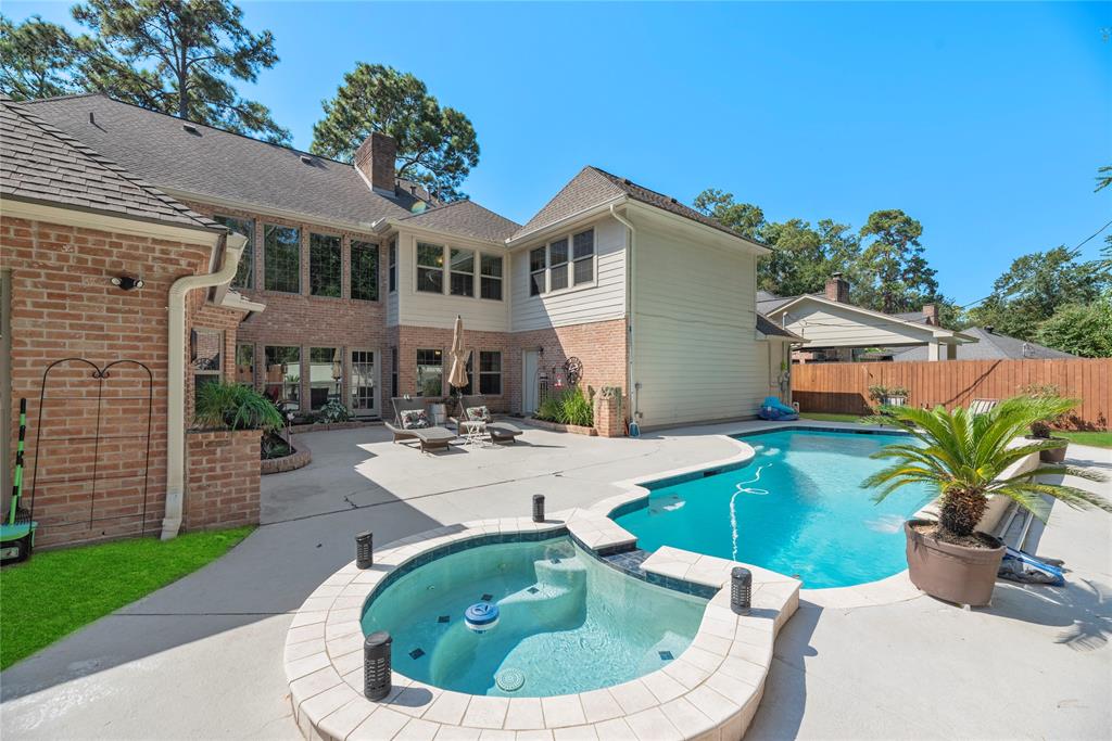 a view of a house with backyard sitting area and swimming pool