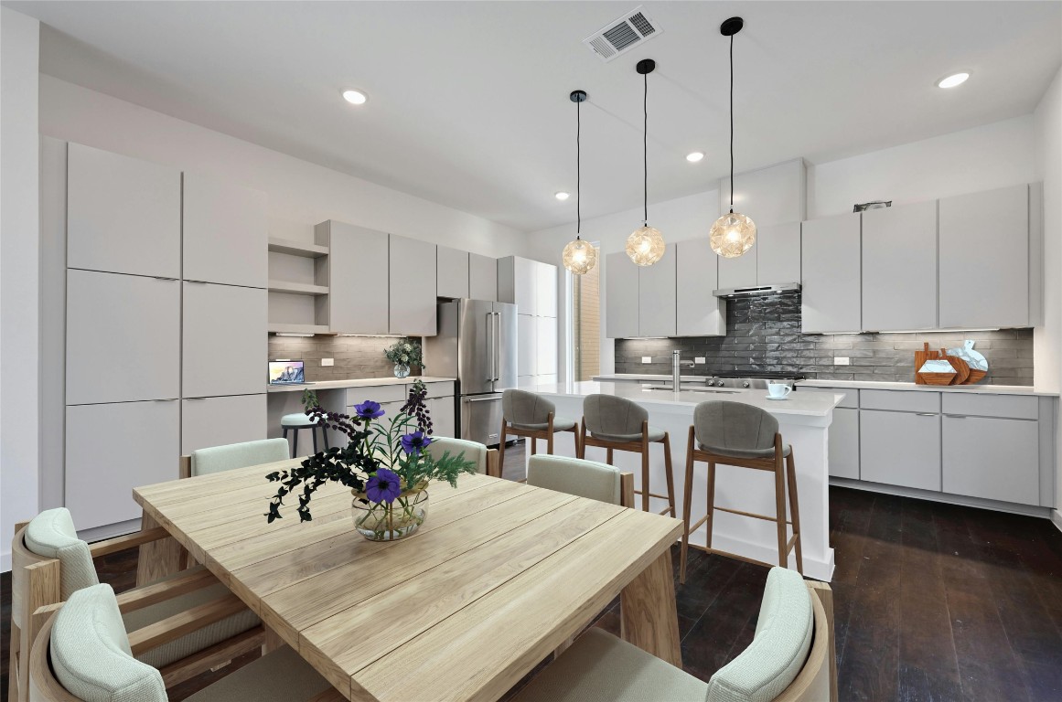 a kitchen with kitchen island a white counter top space a sink and appliances