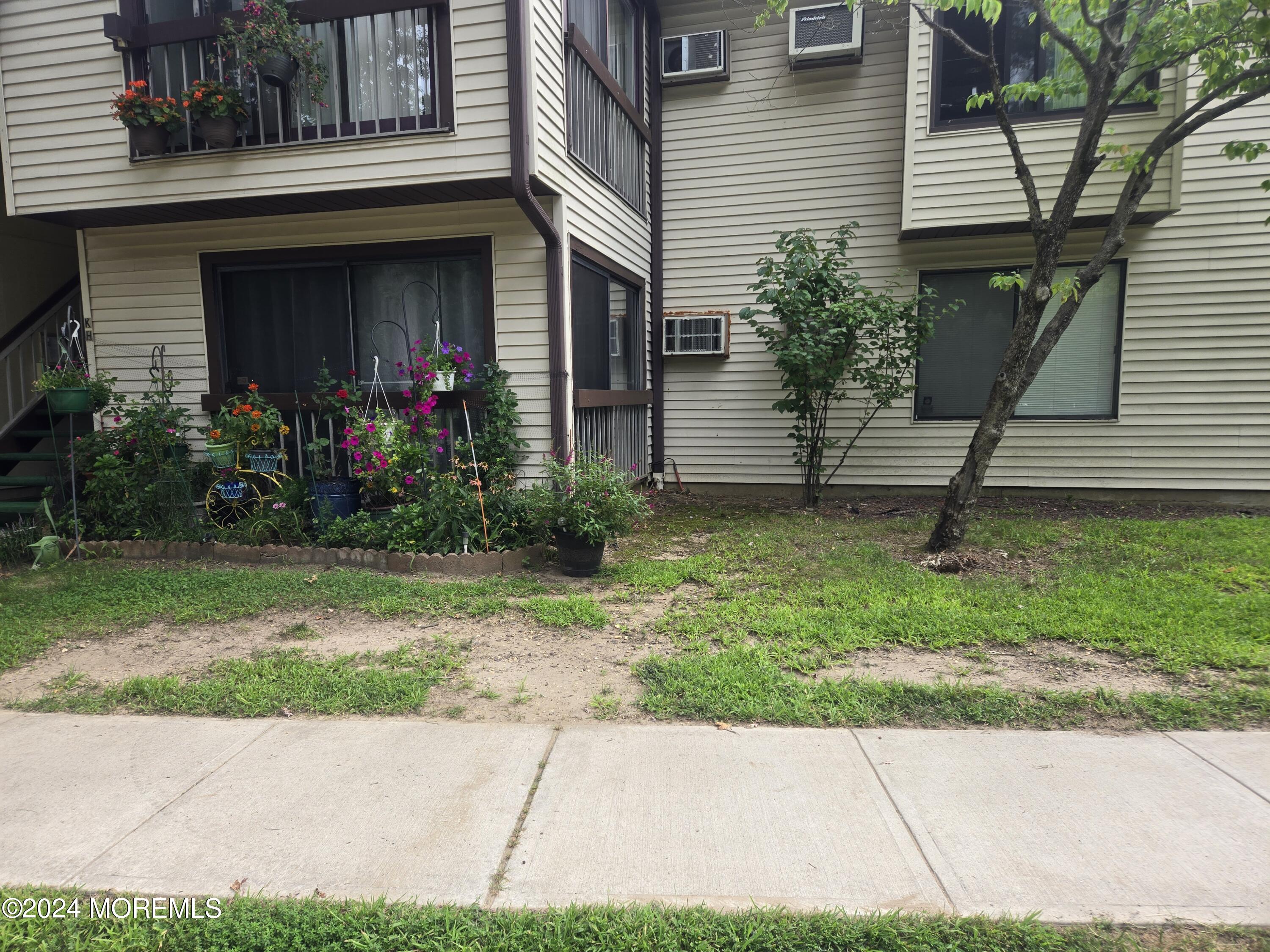 a view of a house with a yard and plants