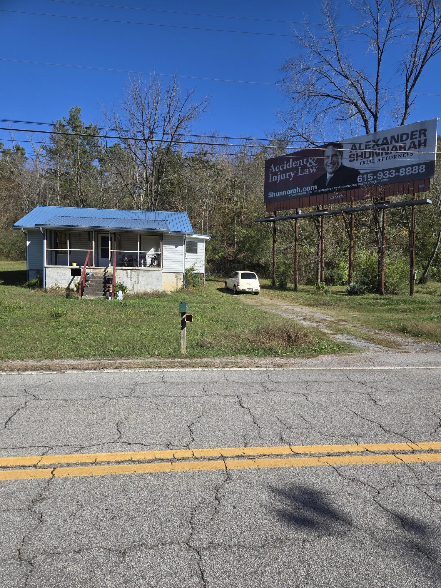 a view of a house with a yard and a garage