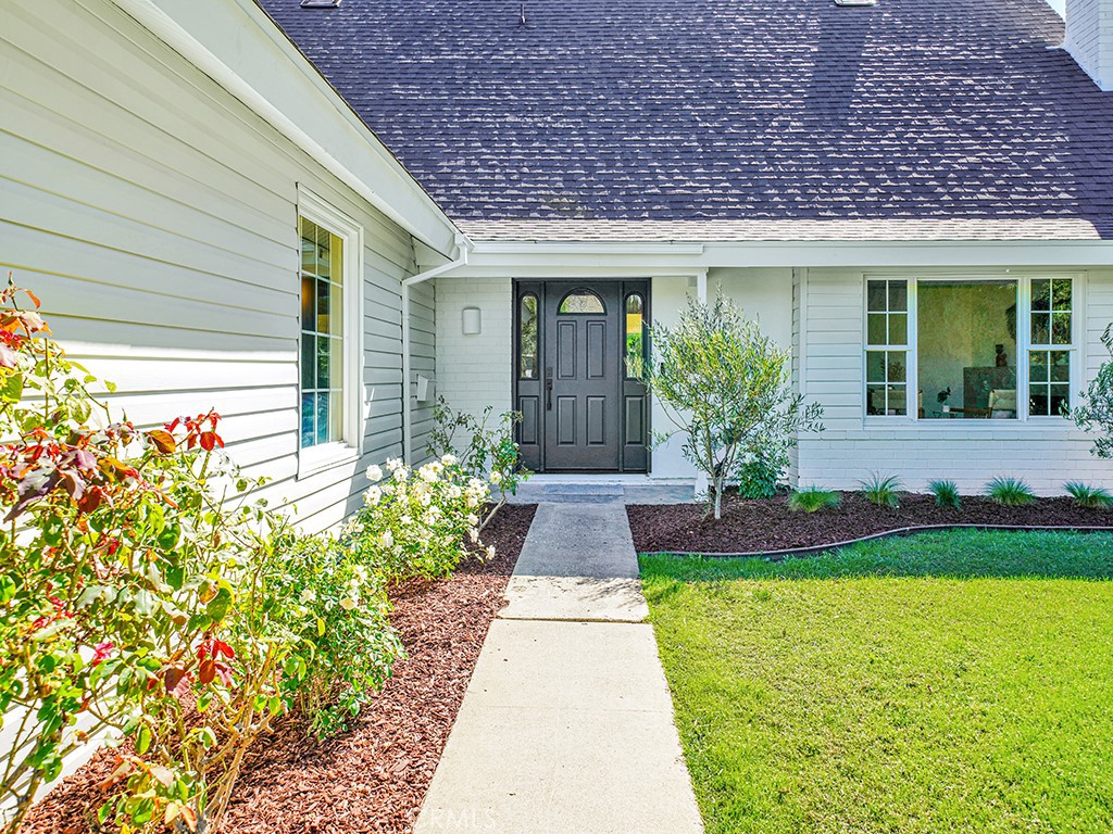 a front view of a house with garden