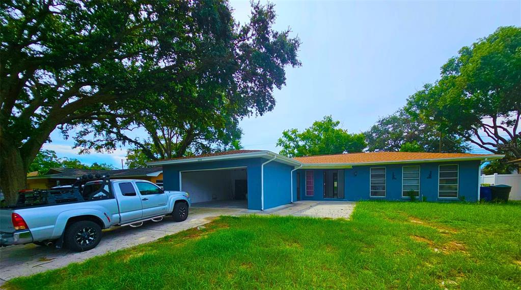 a front view of a house with a garden