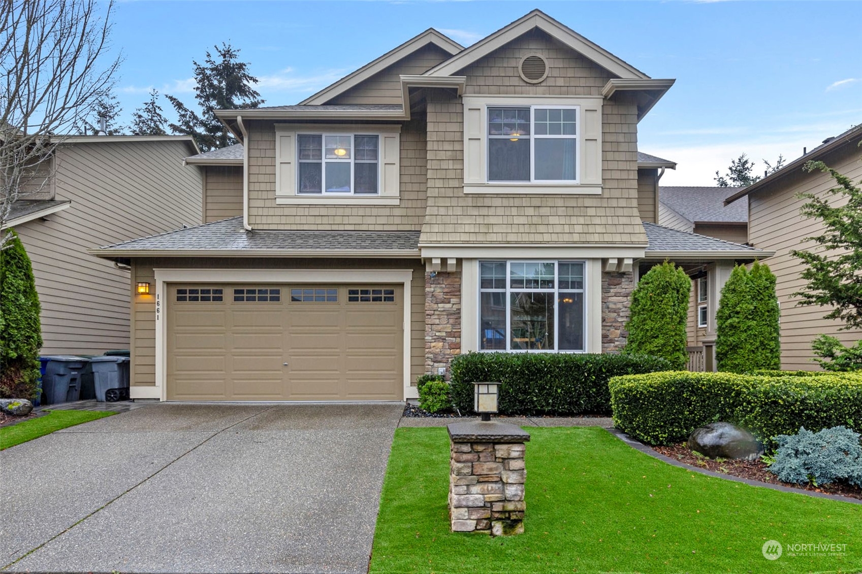 a front view of a house with a yard and garage