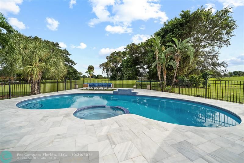 a view of a swimming pool and a yard