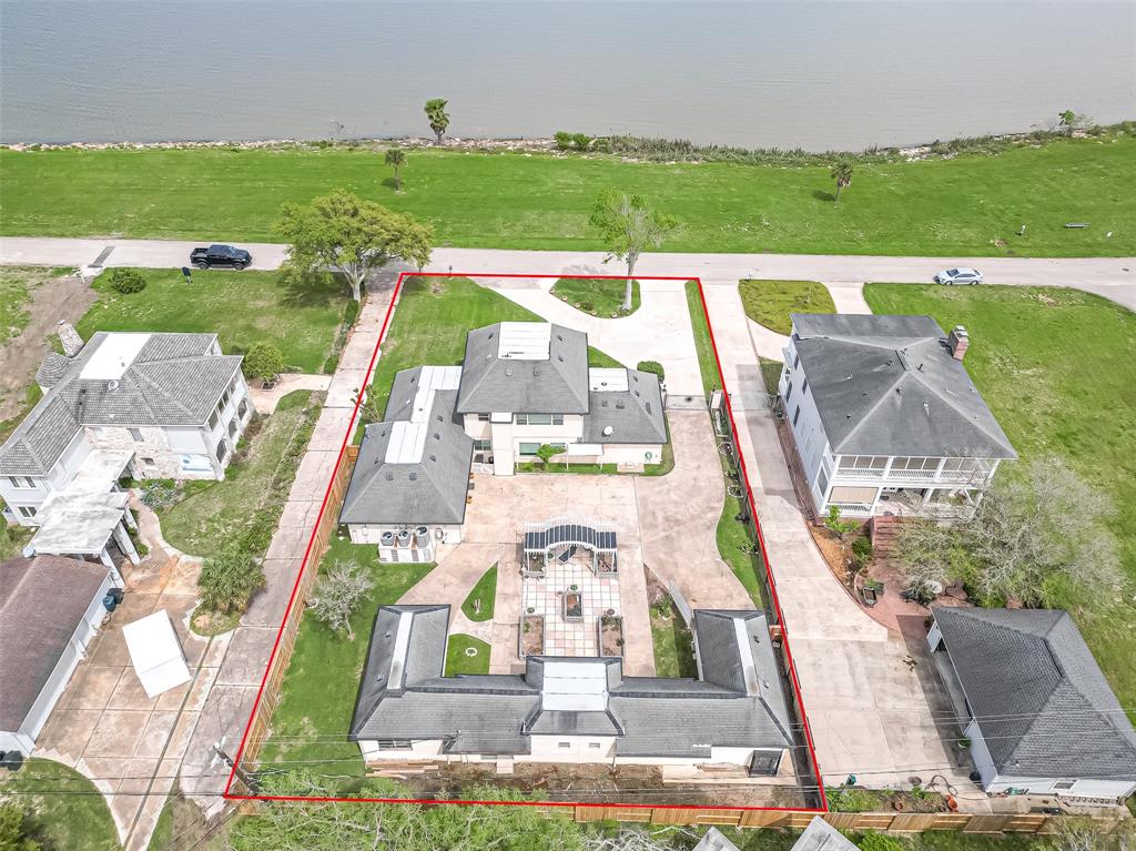 an aerial view of a house with a garden and lake view