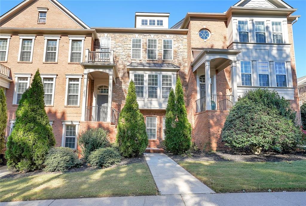 a front view of a residential apartment building with a yard