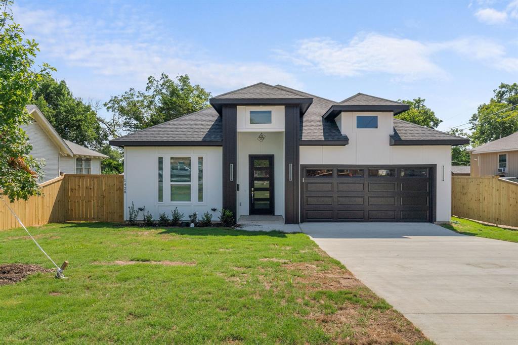 a front view of a house with a yard and garage