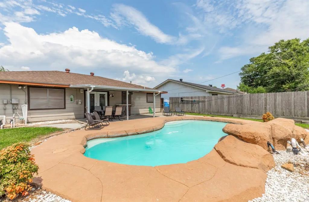 a view of a house with swimming pool and sitting area