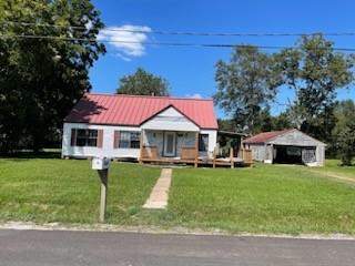 a view of a house with a yard porch and sitting area