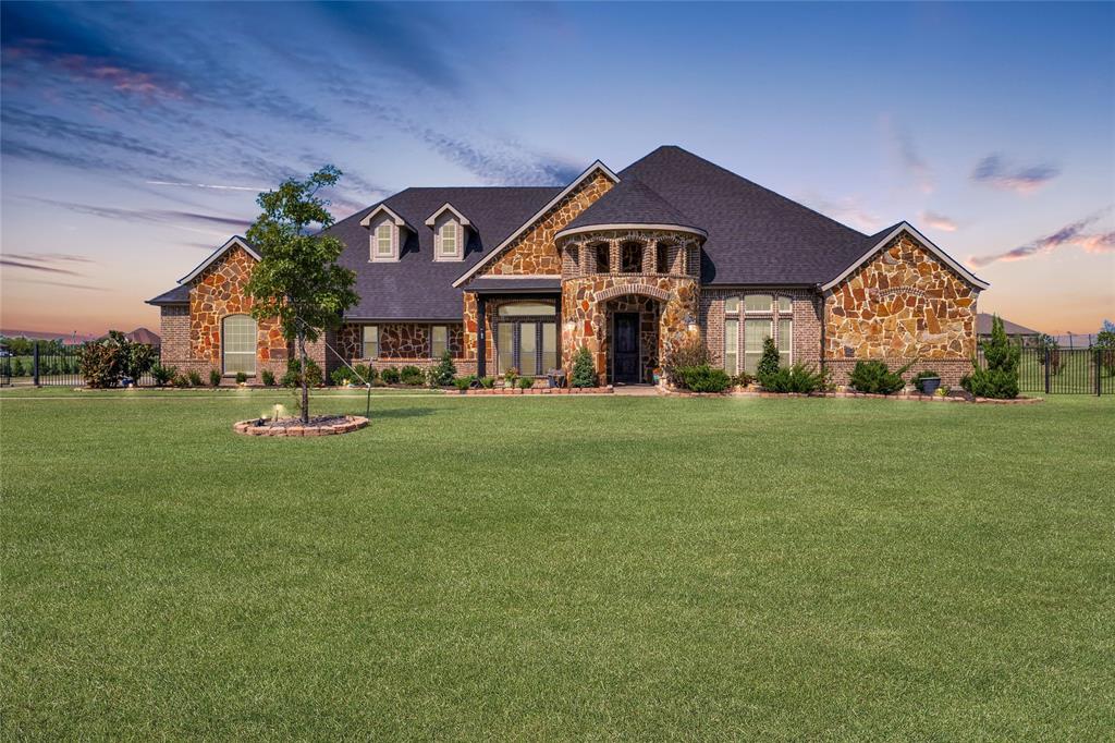 a front view of house with yard and green space