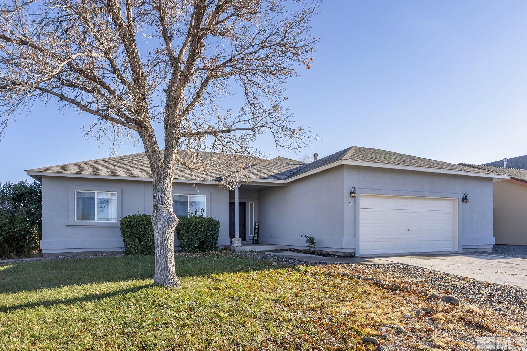 a house that has a tree in front of it