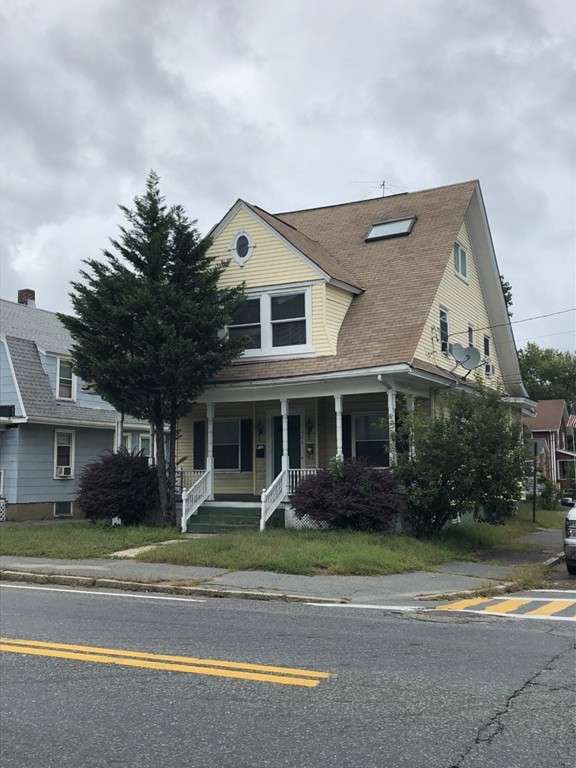 a front view of a house with a garden