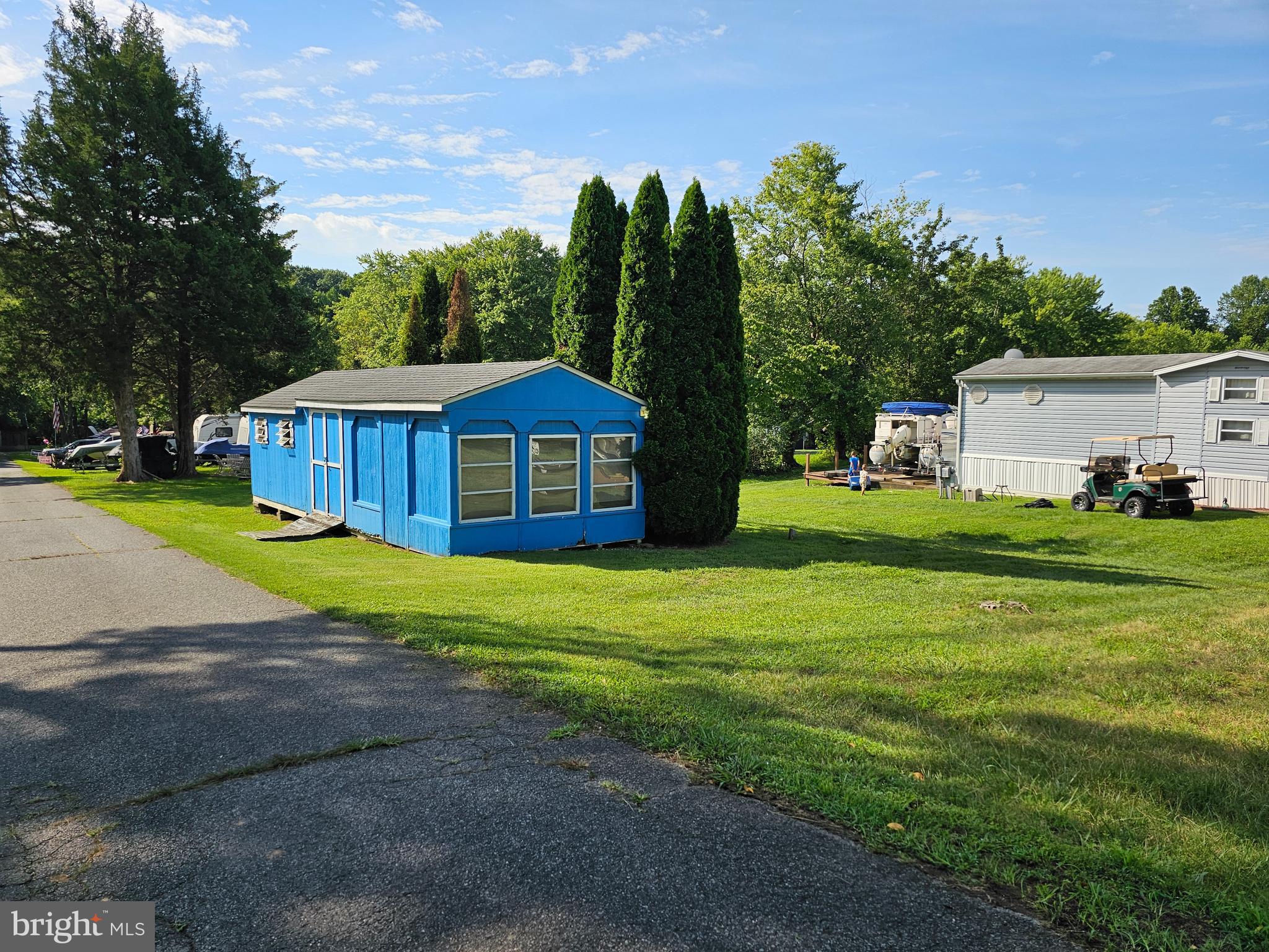 a front view of a house with garden and trees