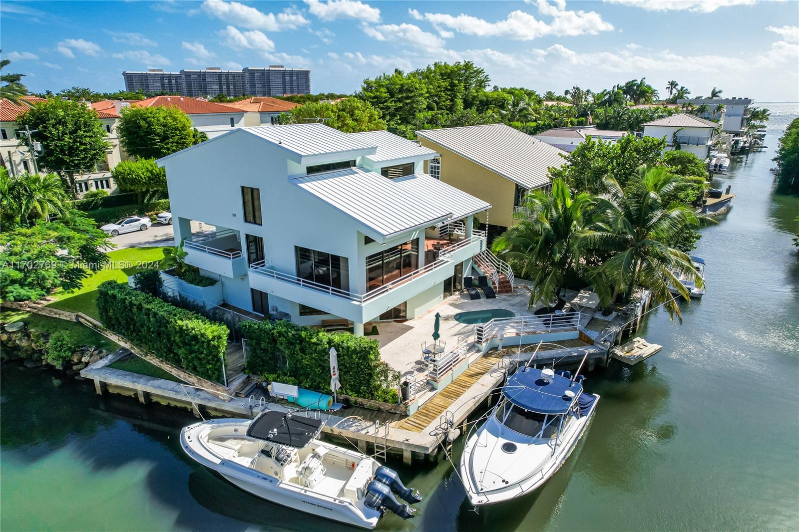 an aerial view of a house with swimming pool and outdoor seating