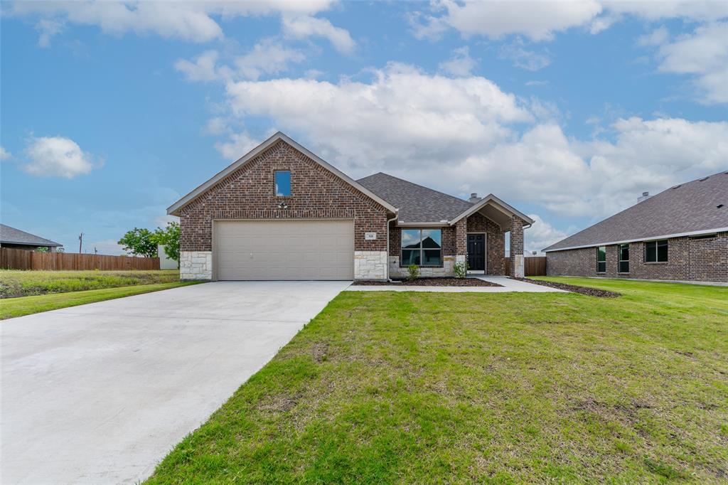 a front view of a house with a yard and garage