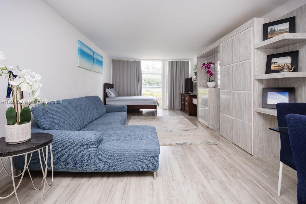 a living room with furniture and a wooden floor