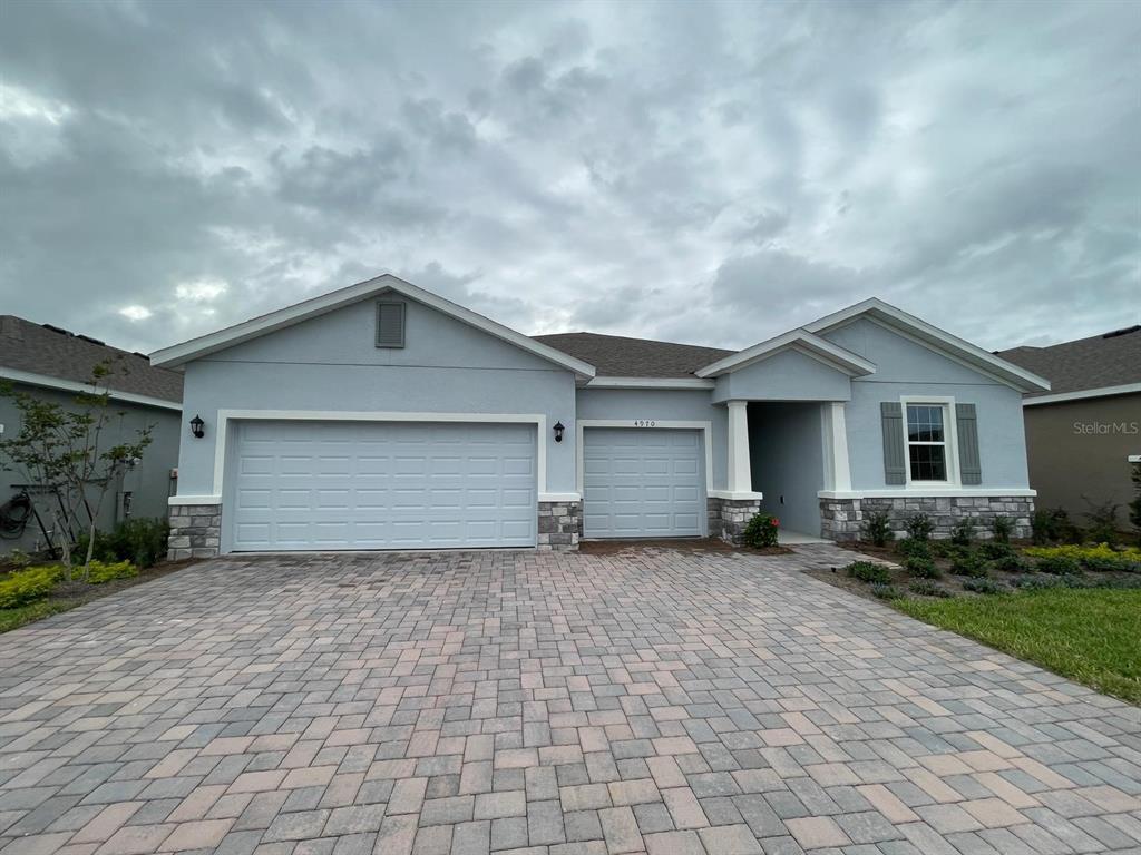 a view of a house with a yard and garage