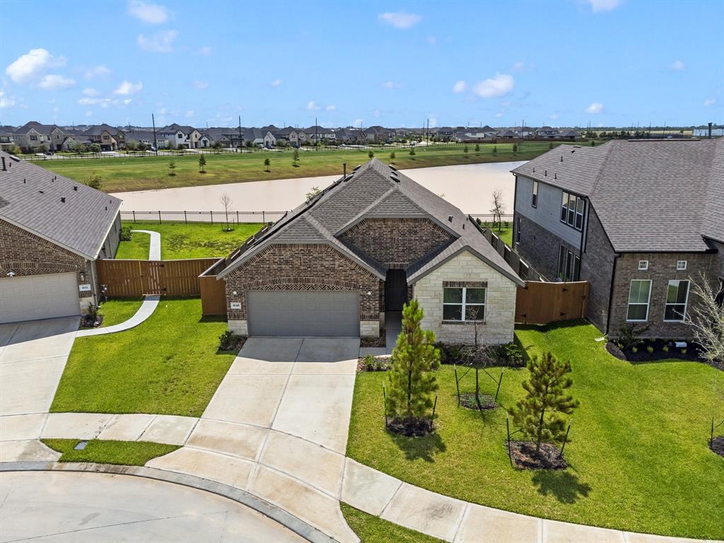 an aerial view of a house with a yard