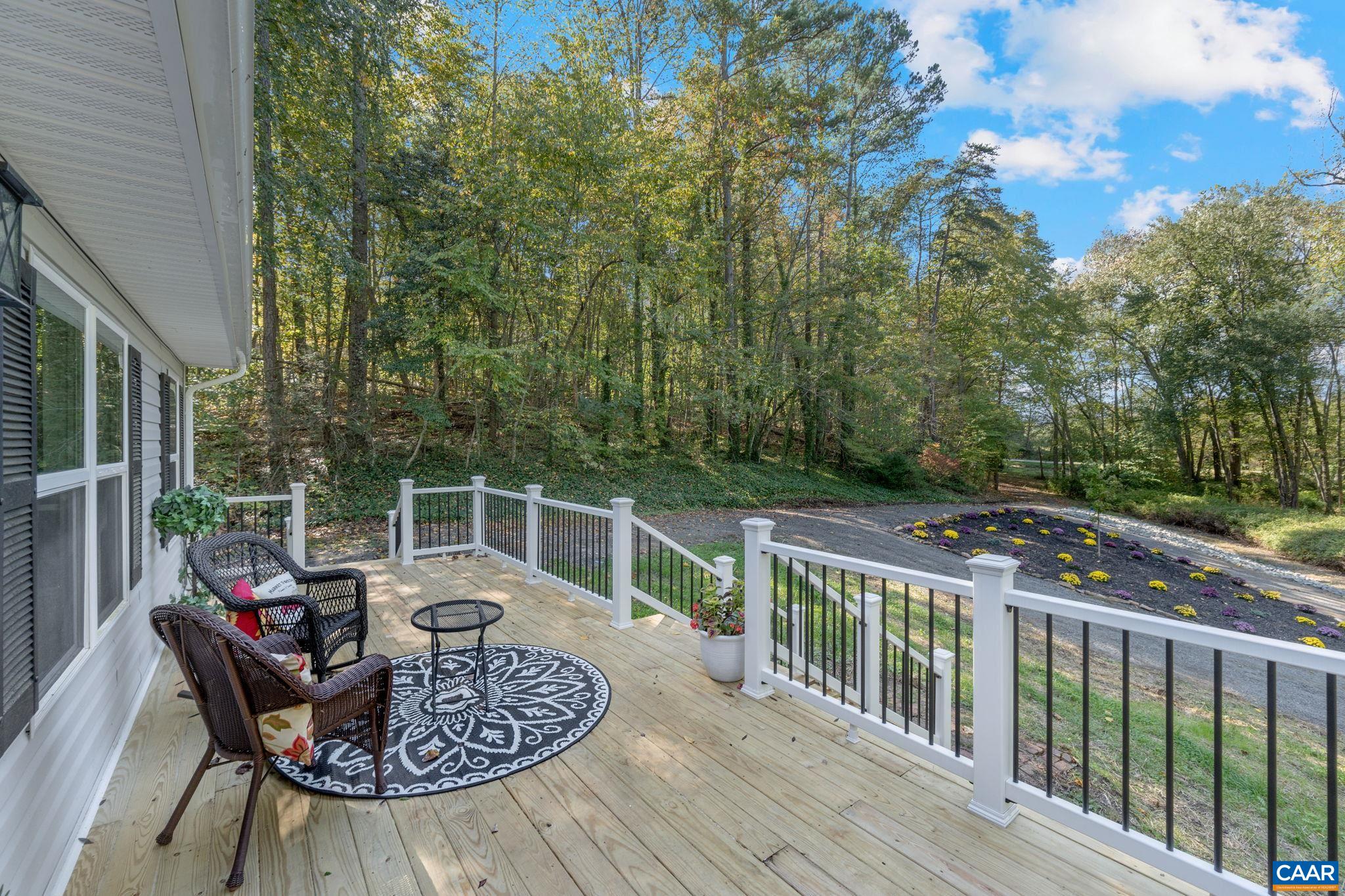 a view of balcony with furniture and garden