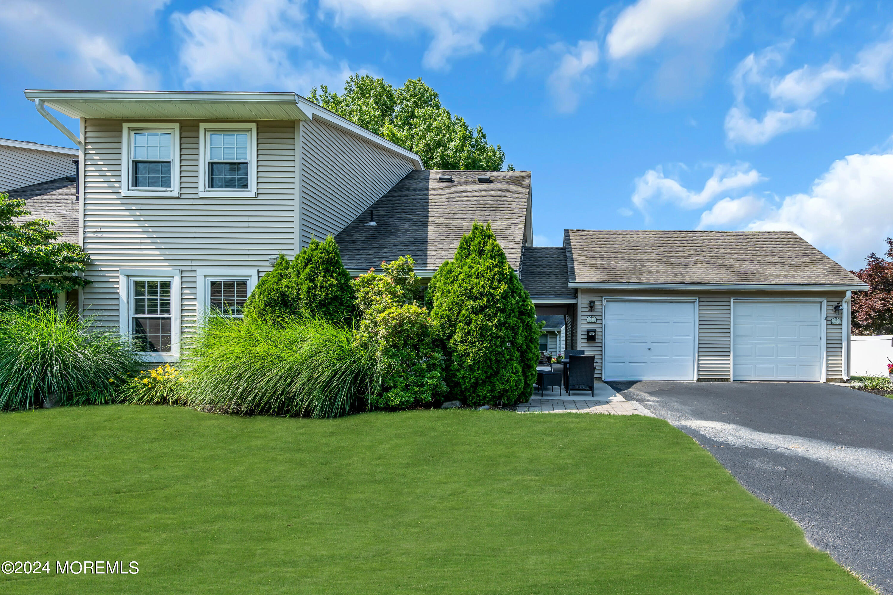 a front view of a house with a garden