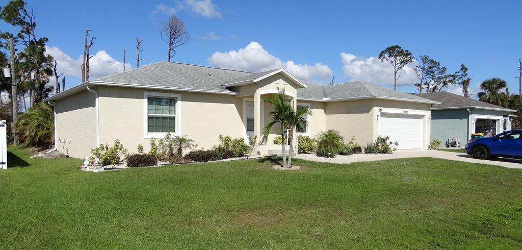 a front view of a house with a garden and yard