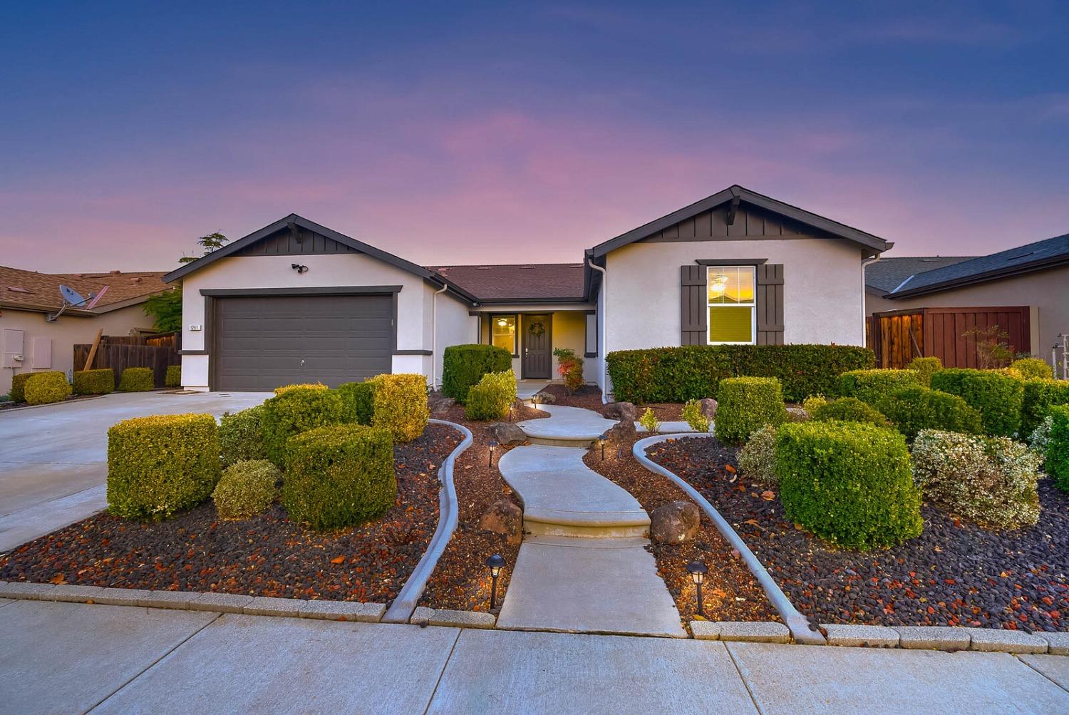 a front view of a house with a yard