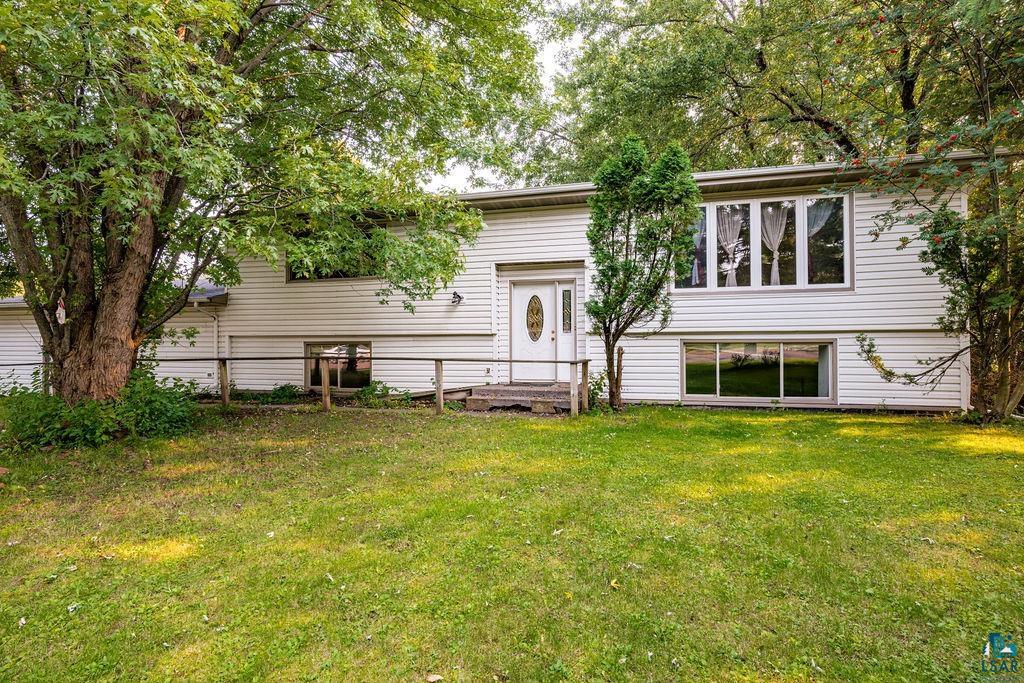 Rear view of house featuring a lawn