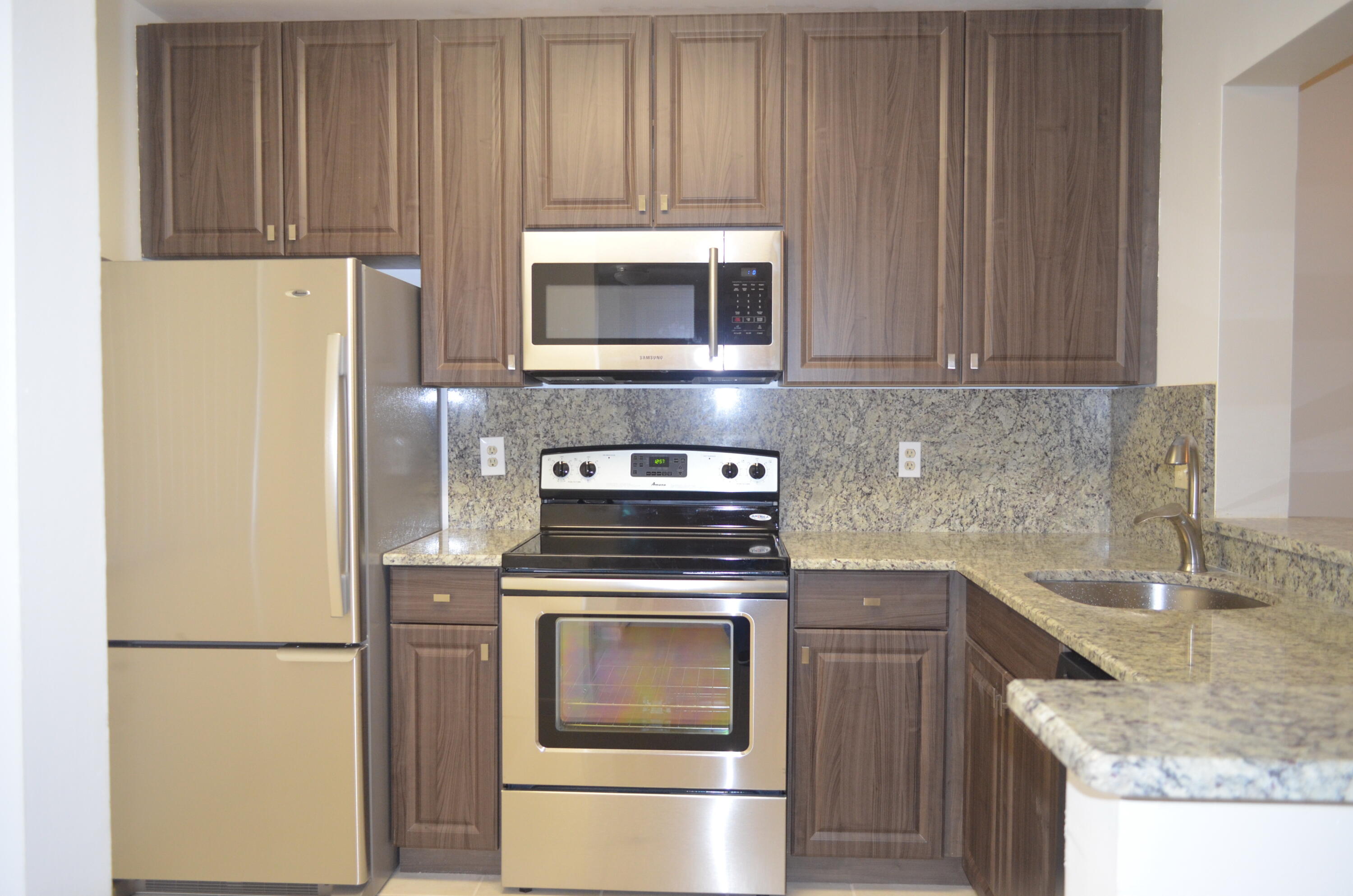 a kitchen with a stove microwave and refrigerator