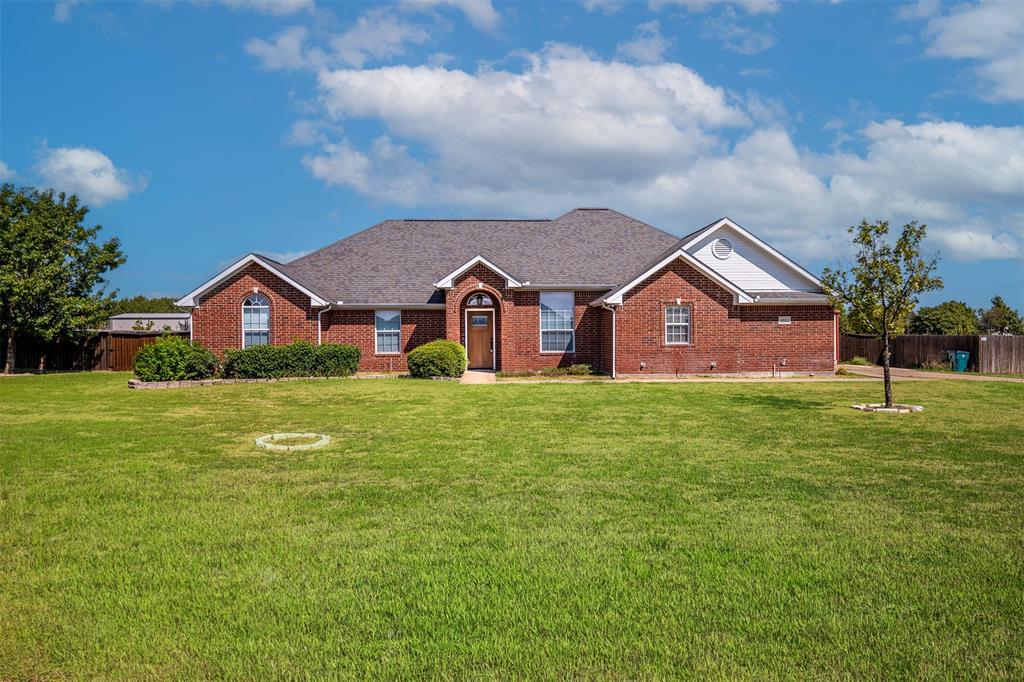 a view of a yard in front of a house with a small yard