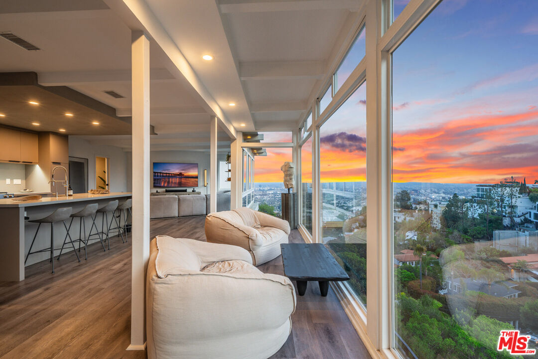 a living room with furniture and a floor to ceiling window