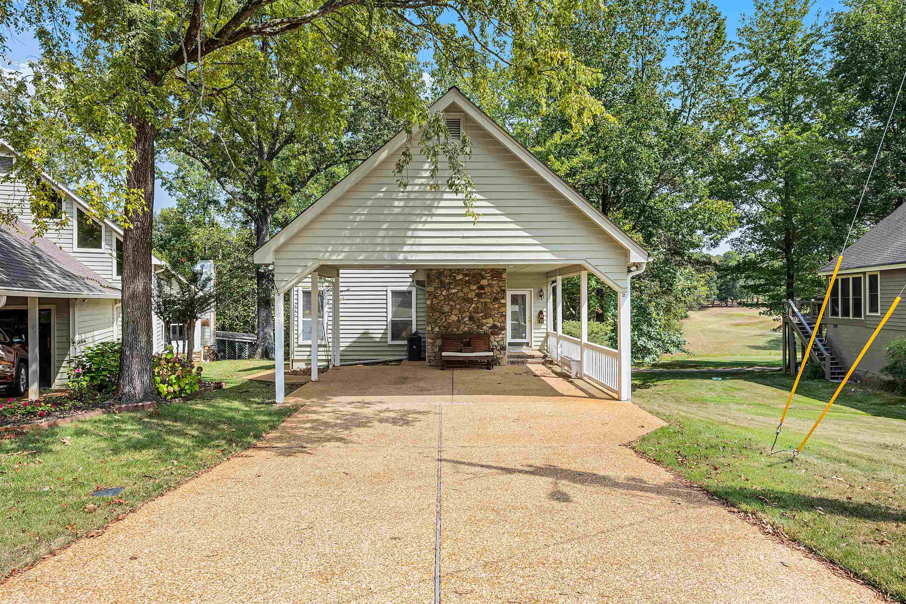 a view of a house with backyard porch and sitting area