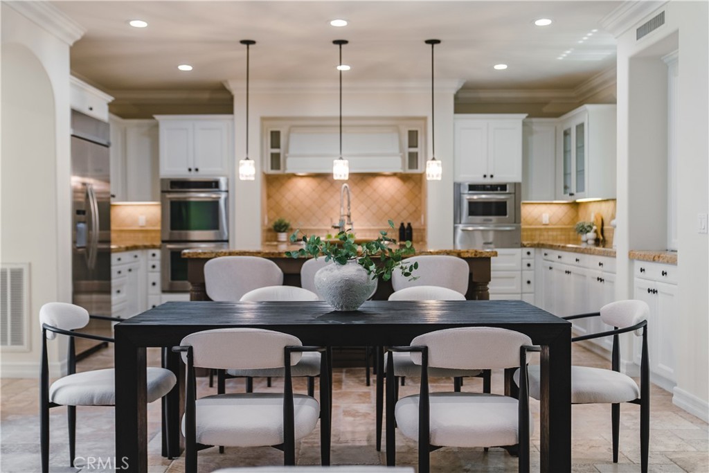 Eat in kitchen with oversized island and drop lighting