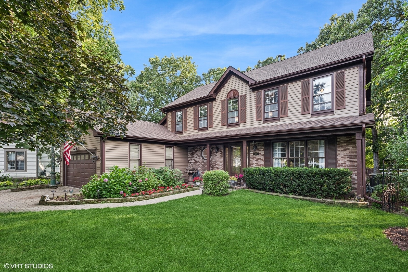 a front view of a house with a garden