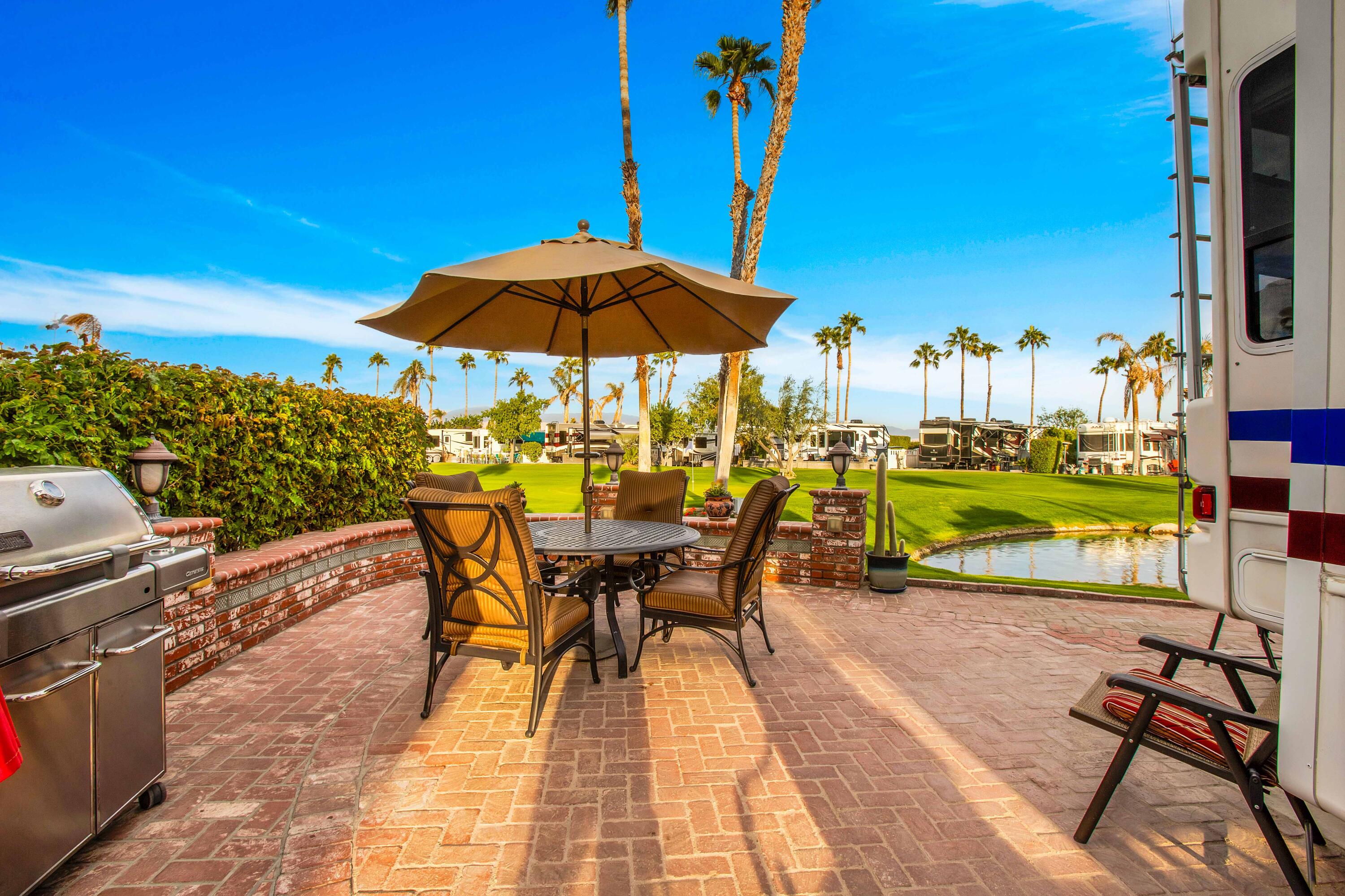 an outdoor space with furniture and umbrella