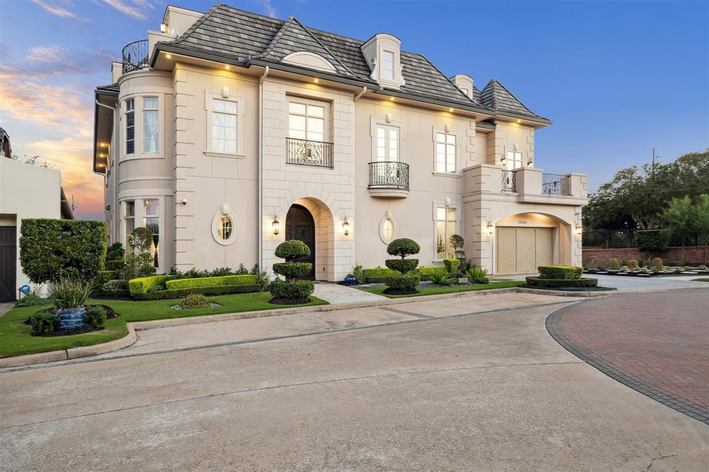 a front view of a house with a yard and a garage