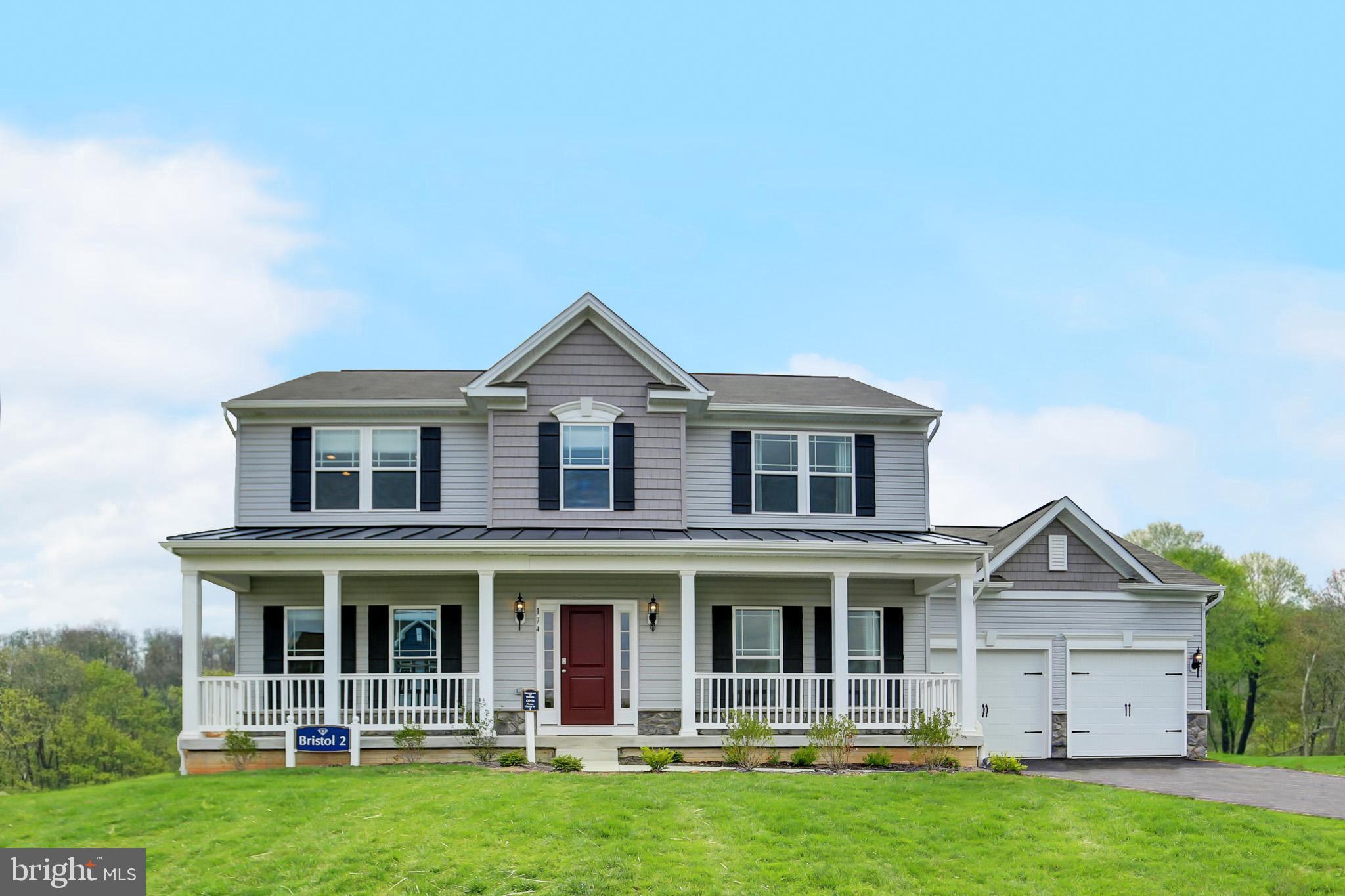 a front view of a house with yard and balcony