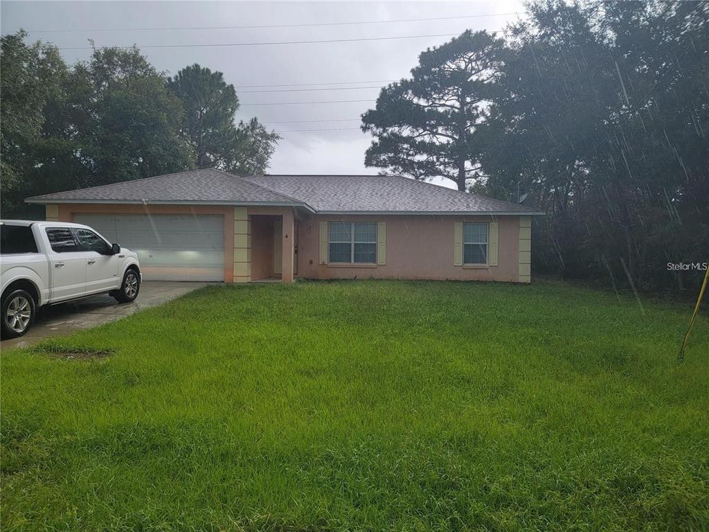 a view of house with backyard