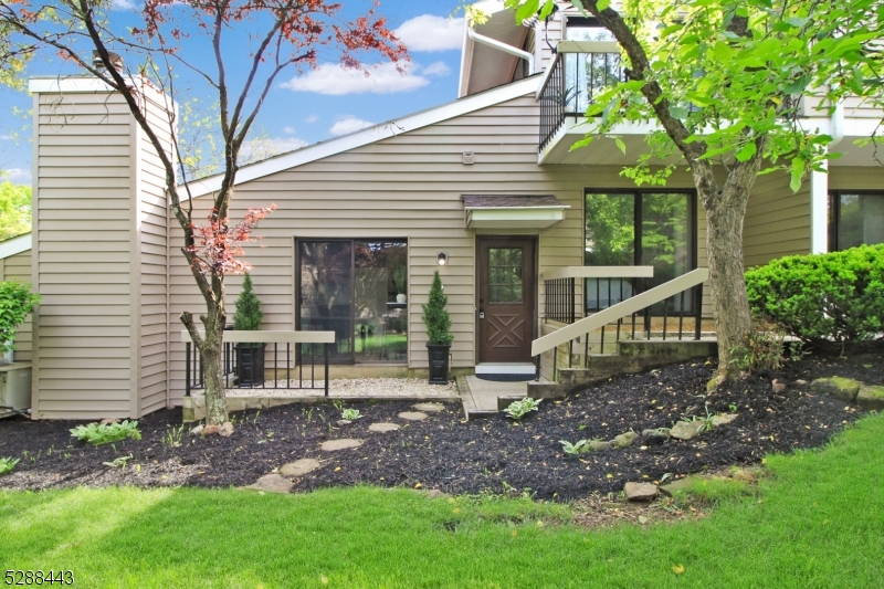 a view of a house with backyard and a tree