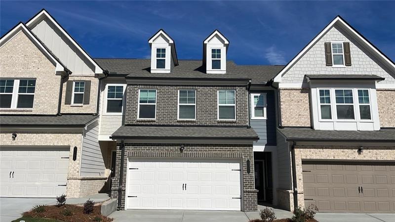 a front view of a house with a garage