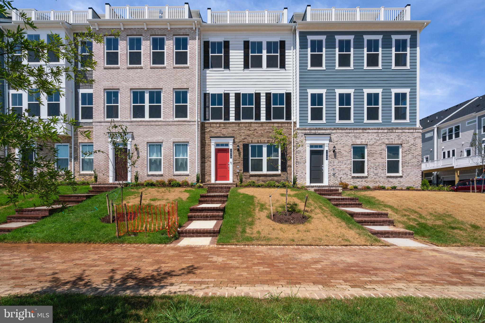 a view of a brick building next to a yard