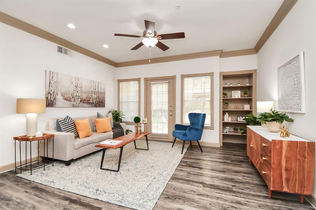 a living room with furniture fireplace and a large window