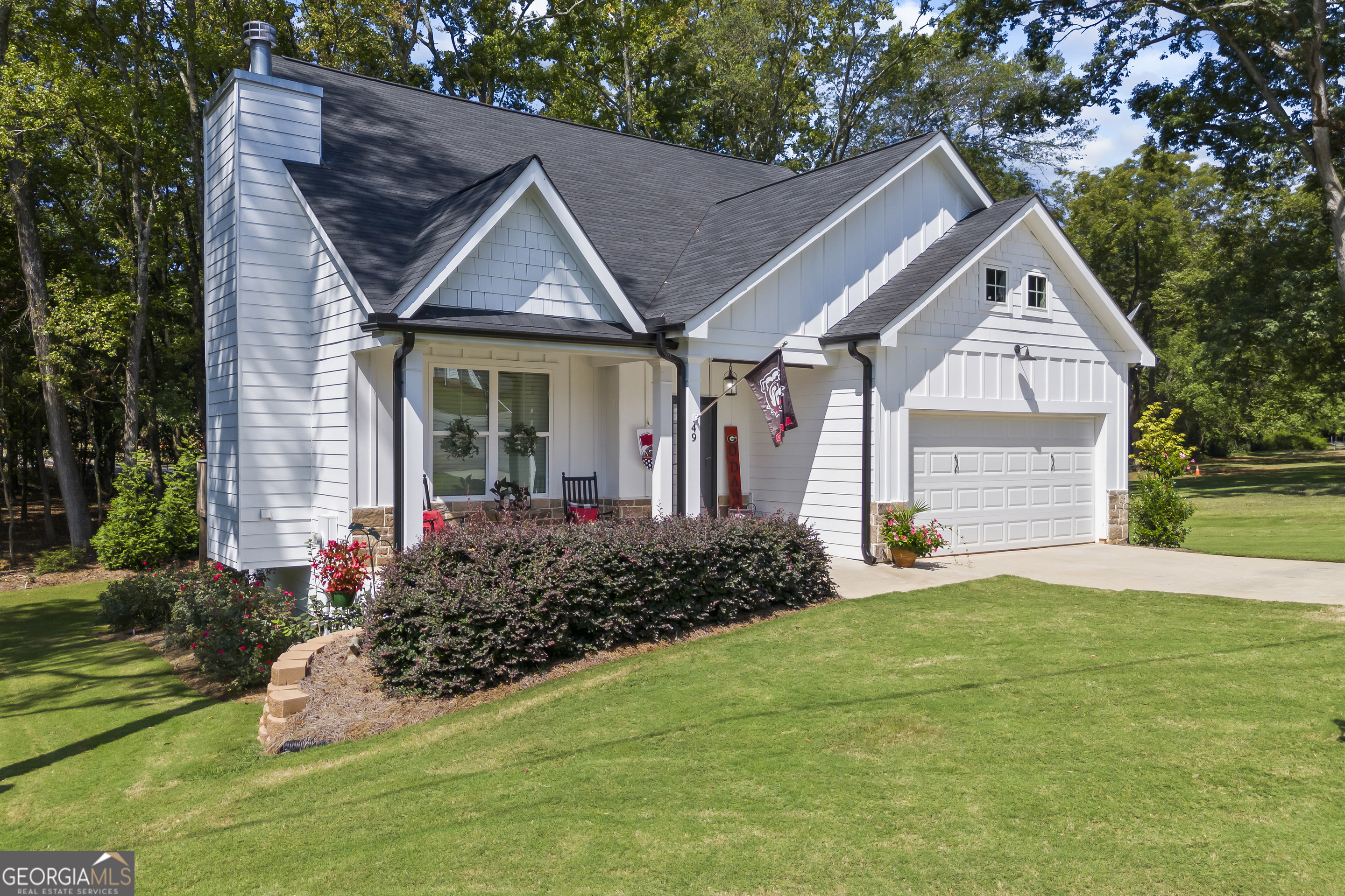 a front view of house with yard and green space