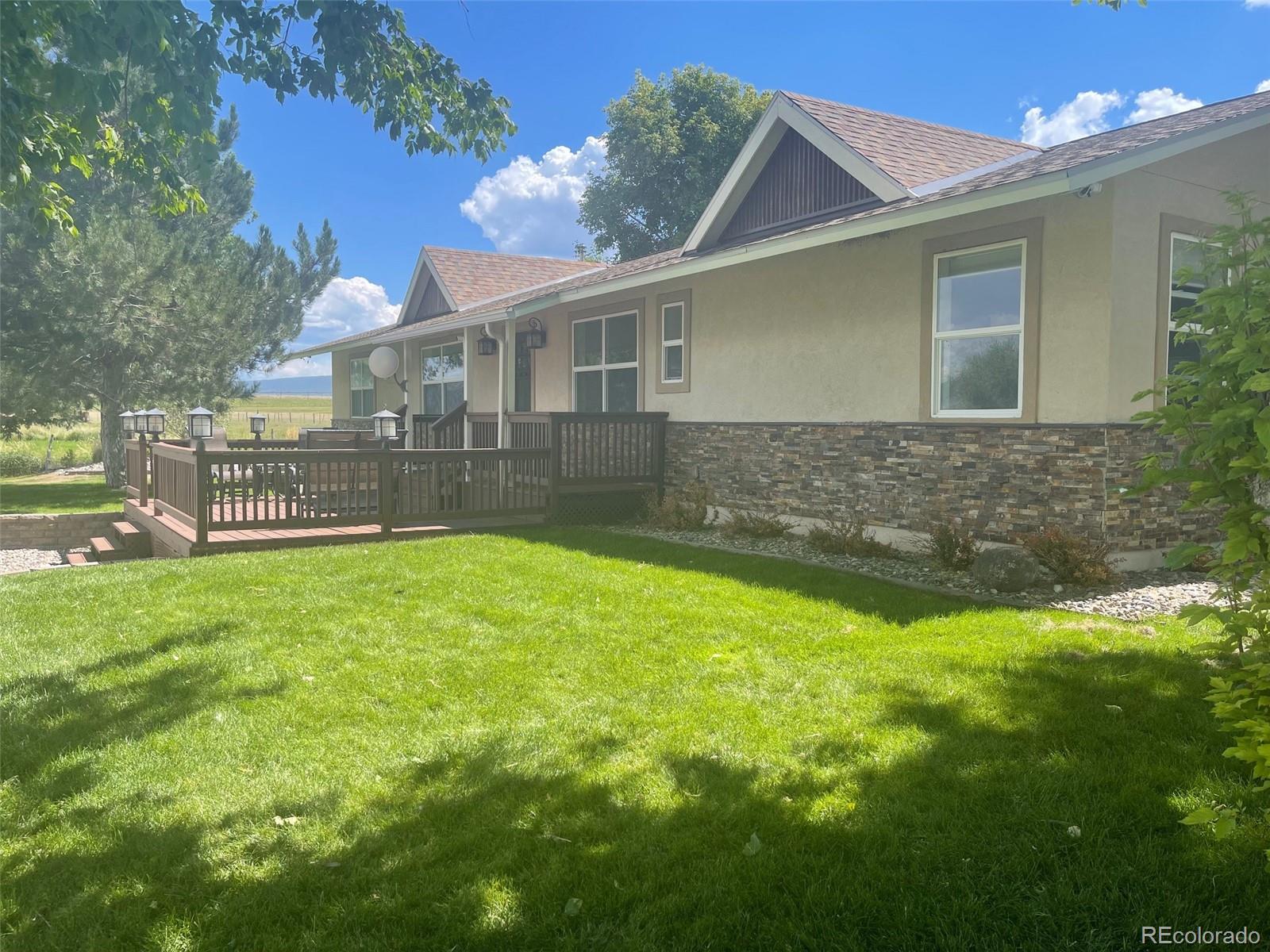 a front view of house with yard and outdoor seating