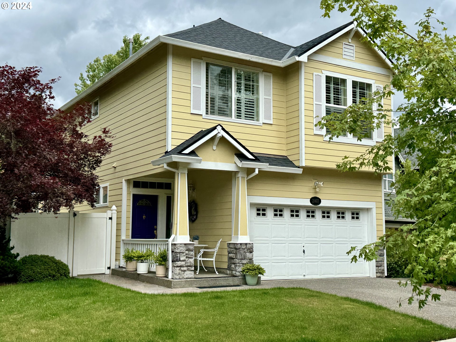 a view of a house with a yard and sitting area