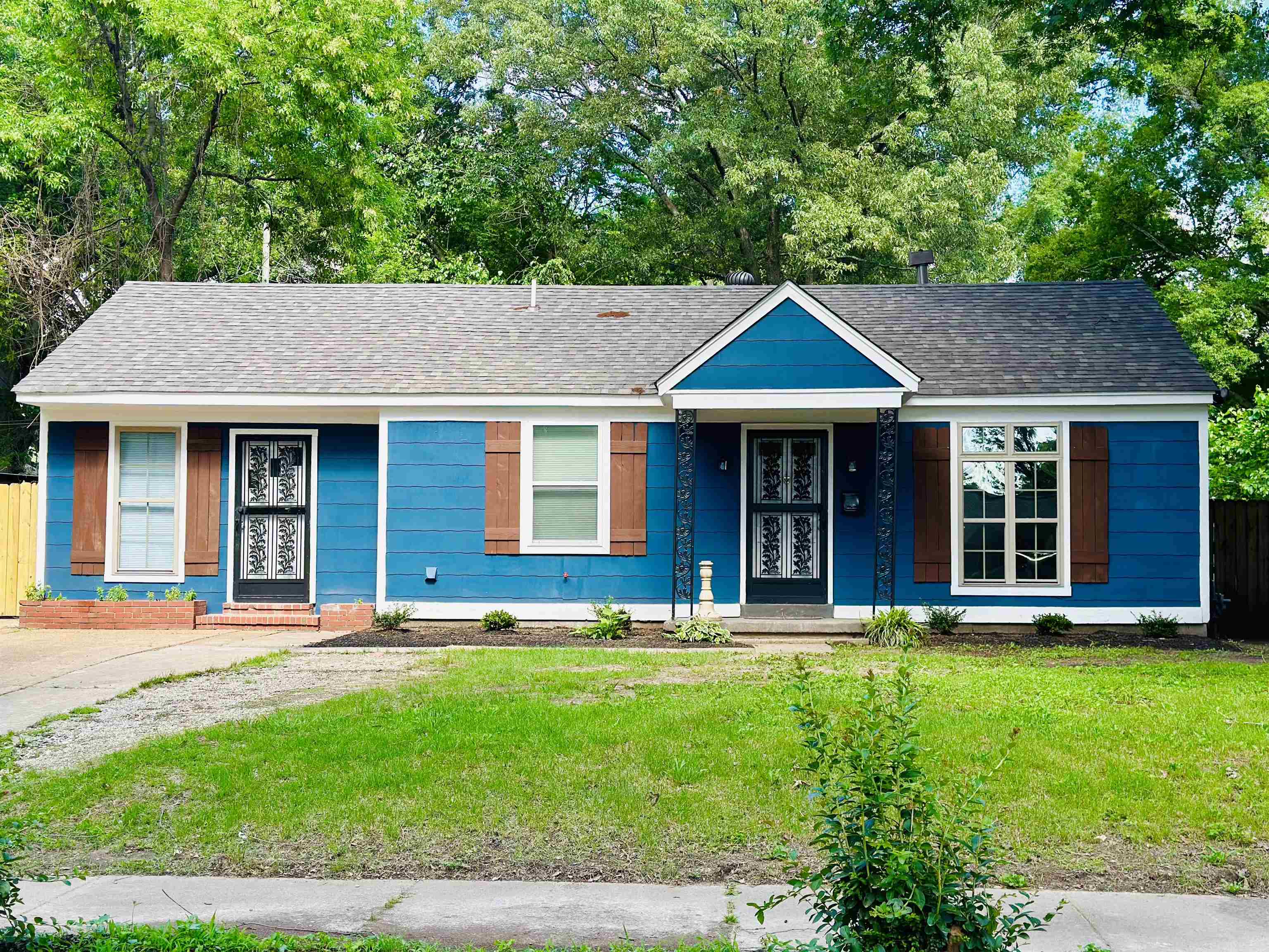 a front view of a house with a garden