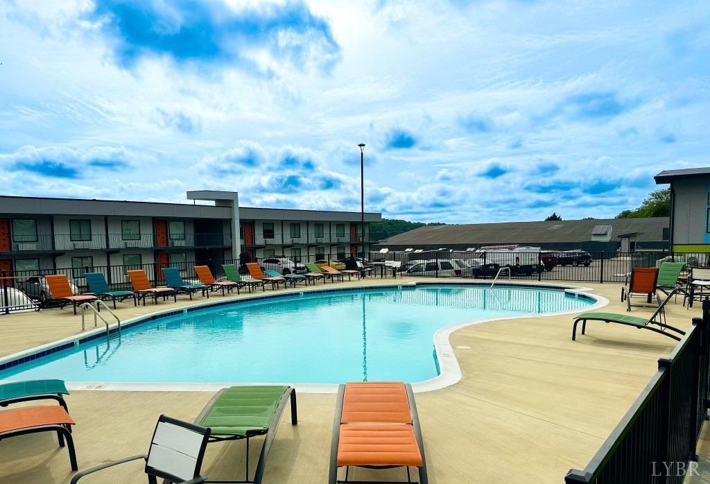 a view of a swimming pool with chairs in patio