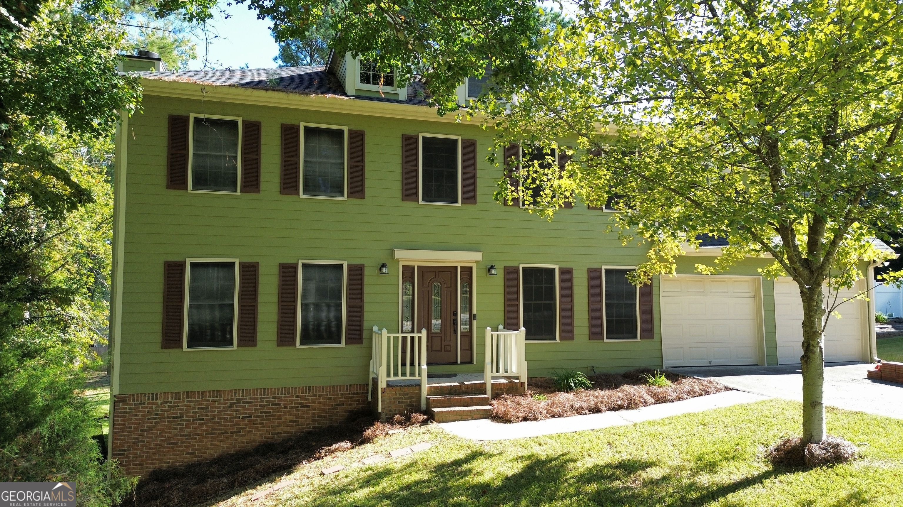 front view of a house with a yard