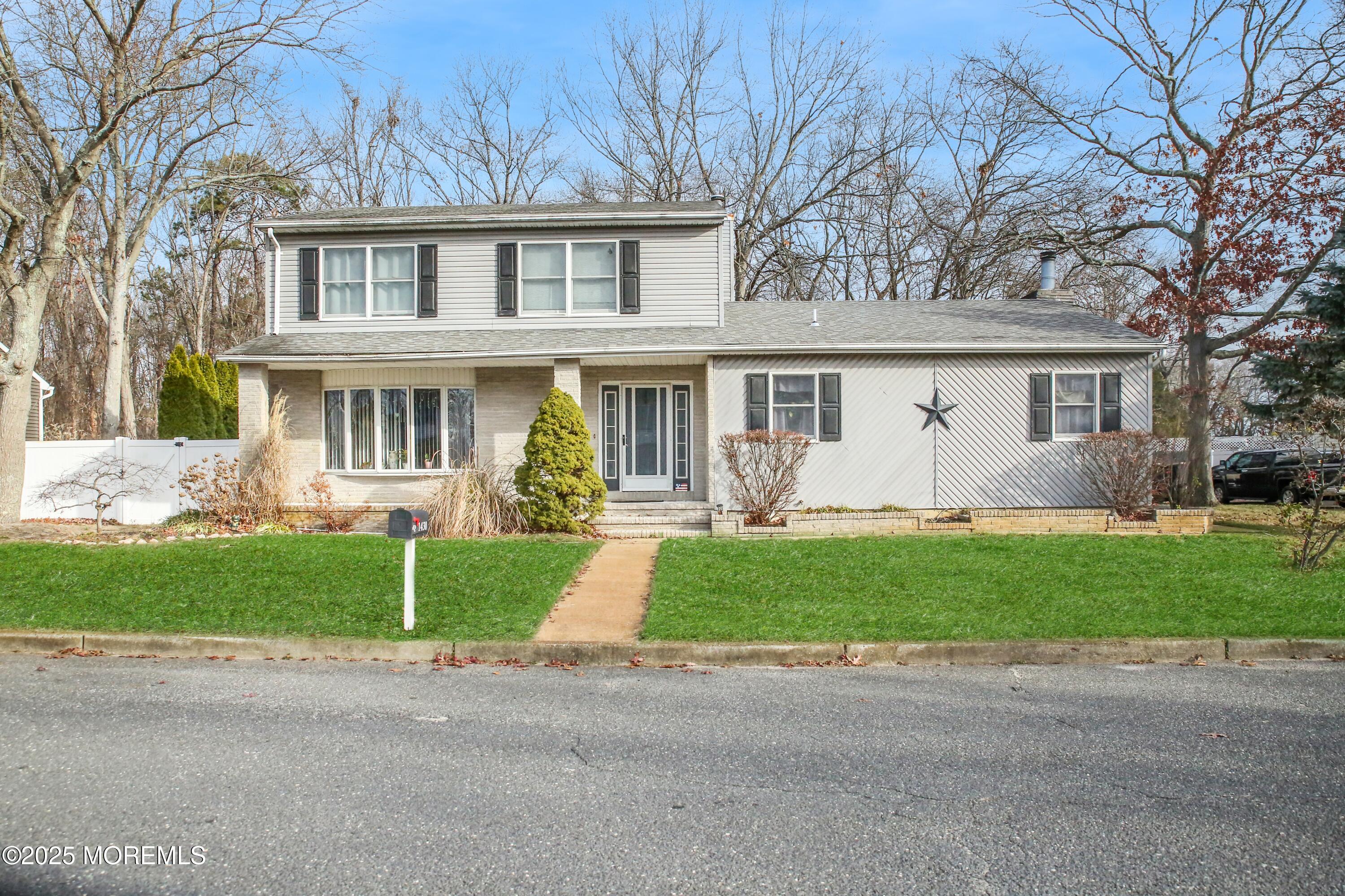 a front view of house with yard and green space